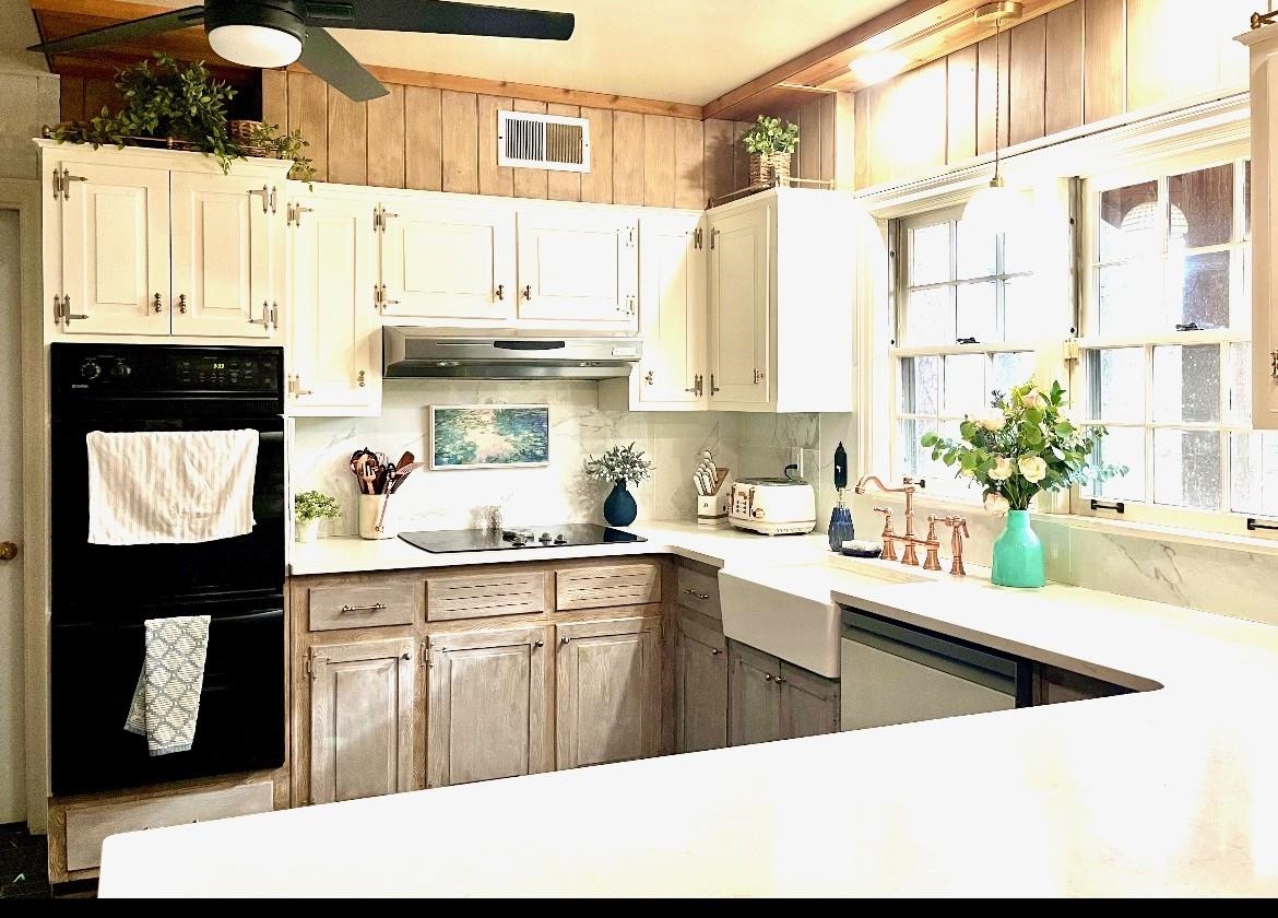 7273 Raleigh Lagrange Road Cordova, TN 38018 - Photo 3 of 30 Kitchen featuring light countertops, under cabinet range hood, dishwashing machine, and white cabinets
