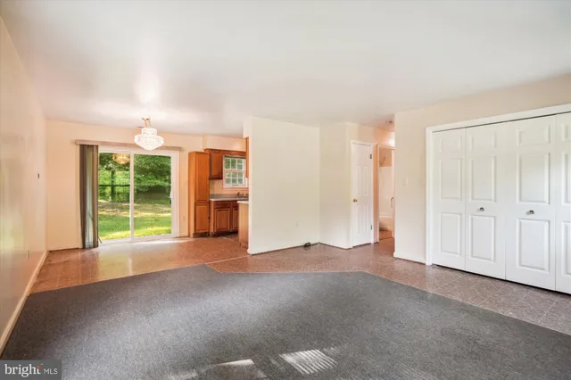 a view of a big room with windows and kitchen view