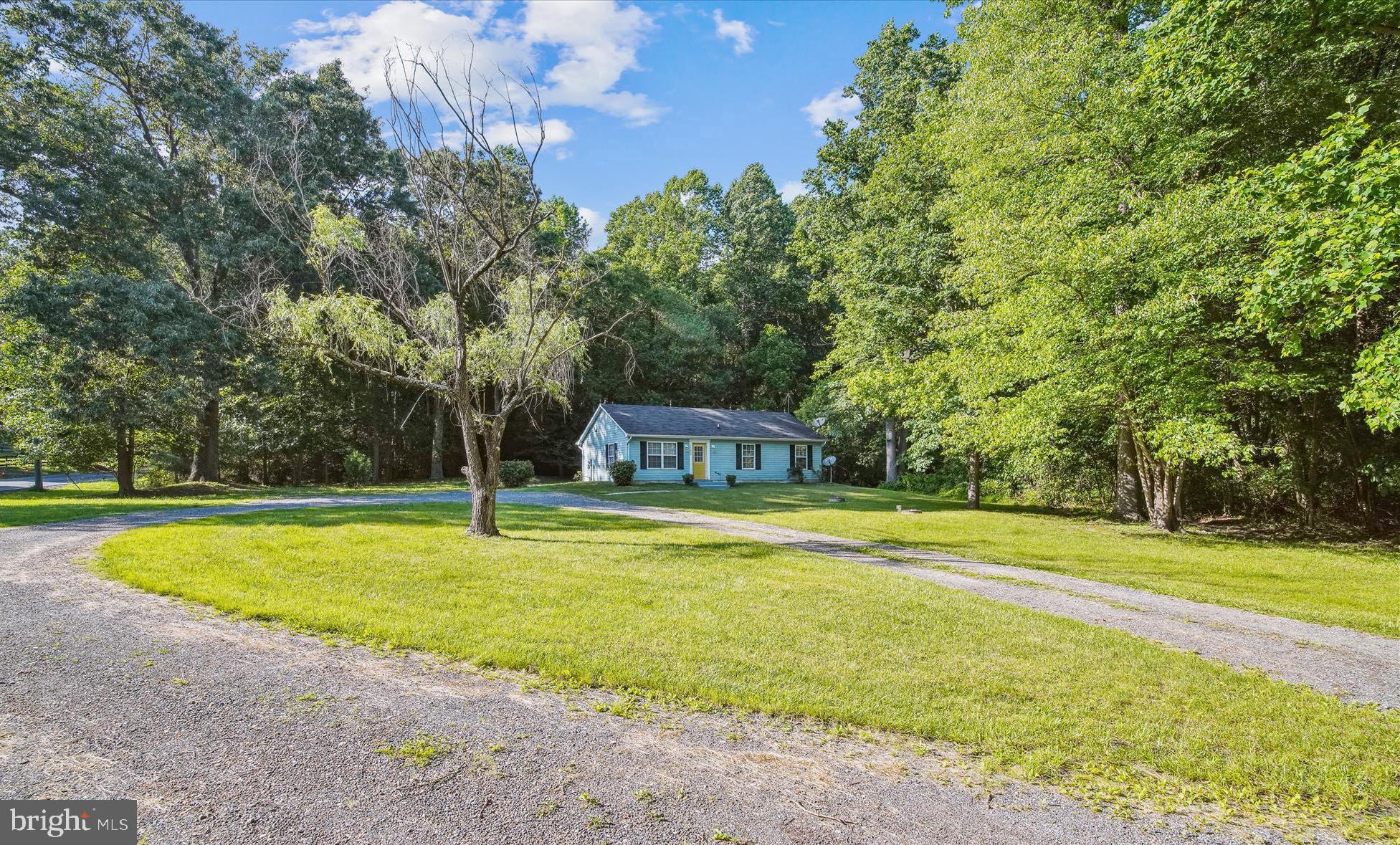 14050 Oaks Road Hughesville, MD 20637 - Photo 21 of 22 a view of a swimming pool with lawn chairs and large trees