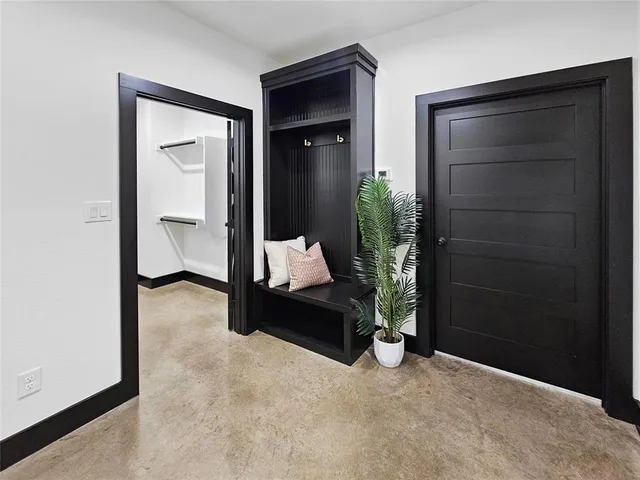 a living room with furniture and white wall painting
