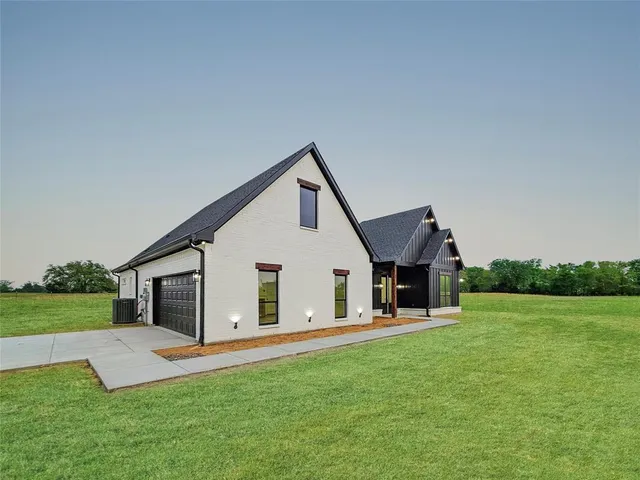 a front view of house with yard and green space