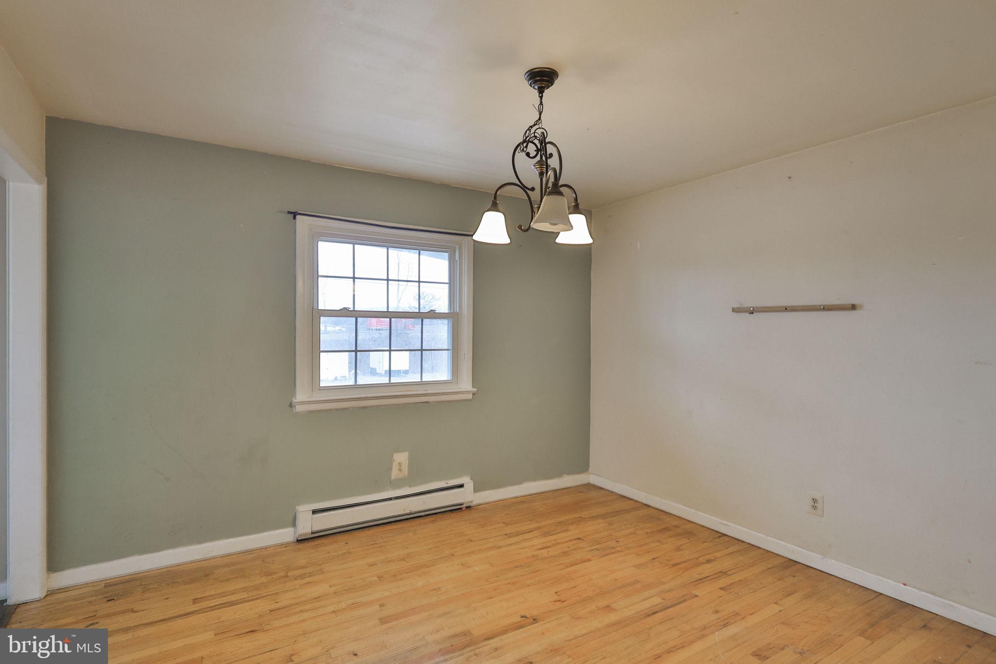 210 South 16th Street Emmaus, PA 18049 - Photo 15 of 92 a view of an empty room with wooden floor and a window