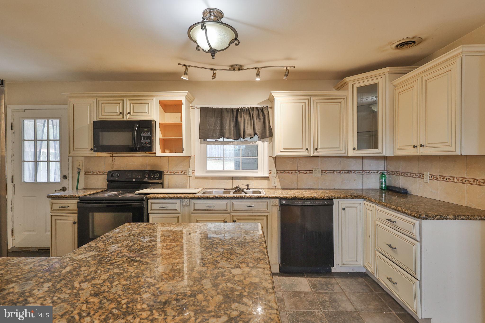 210 South 16th Street Emmaus, PA 18049 - Photo 17 of 92 a kitchen with kitchen island granite countertop a stove sink and microwave