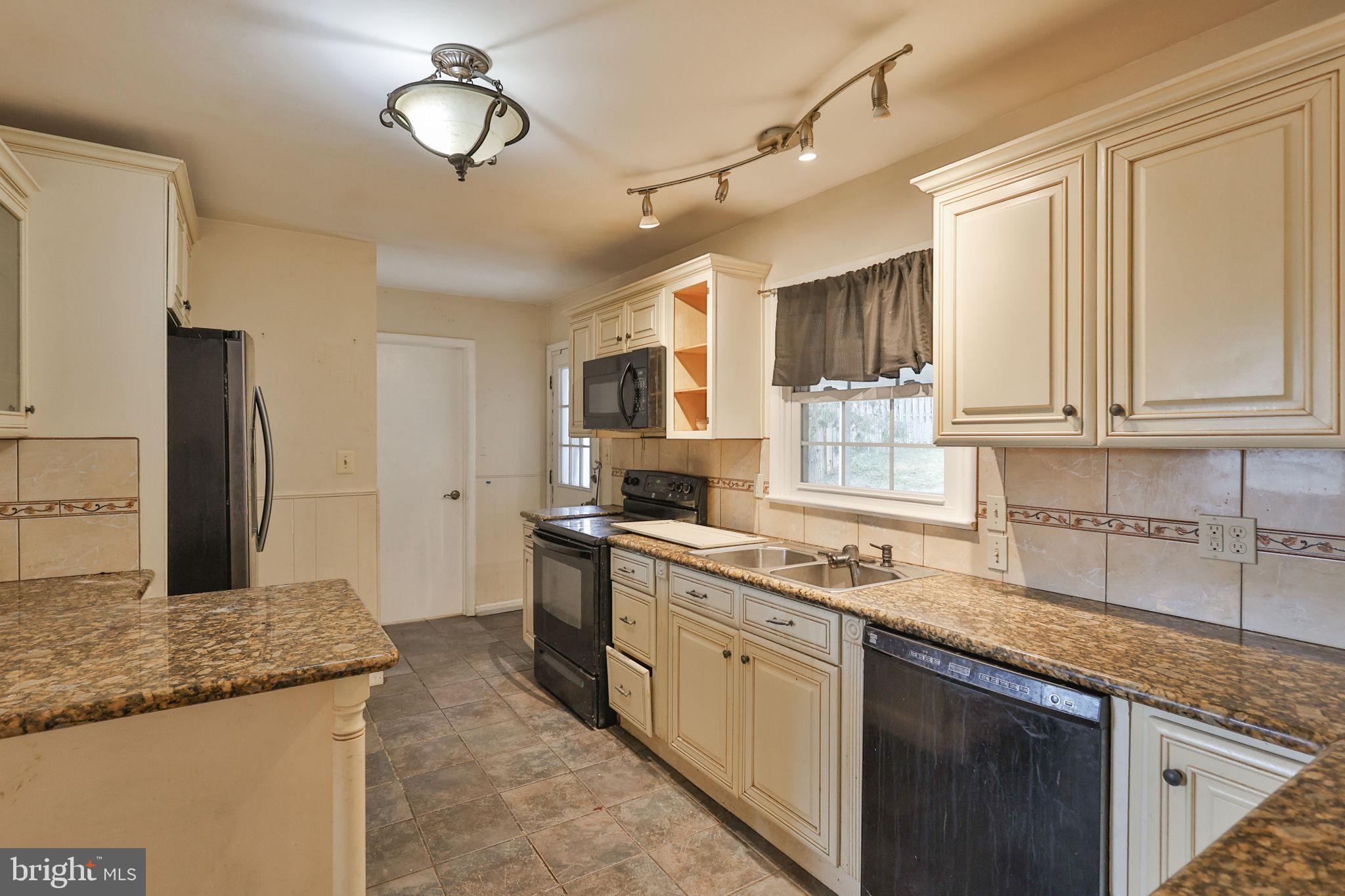210 South 16th Street Emmaus, PA 18049 - Photo 18 of 92 a kitchen with stainless steel appliances granite countertop a sink a stove cabinets and a refrigerator