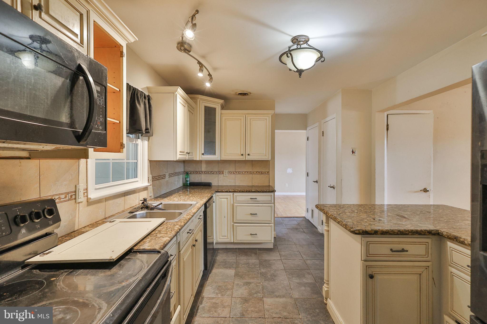 210 South 16th Street Emmaus, PA 18049 - Photo 21 of 92 a kitchen with a stove sink and cabinets
