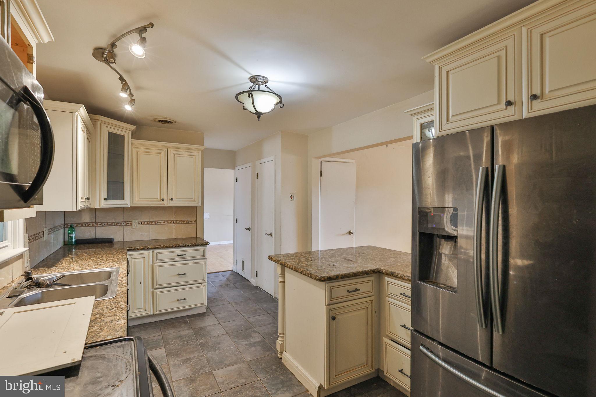 210 South 16th Street Emmaus, PA 18049 - Photo 22 of 92 a kitchen with stainless steel appliances granite countertop a refrigerator a sink and white cabinets