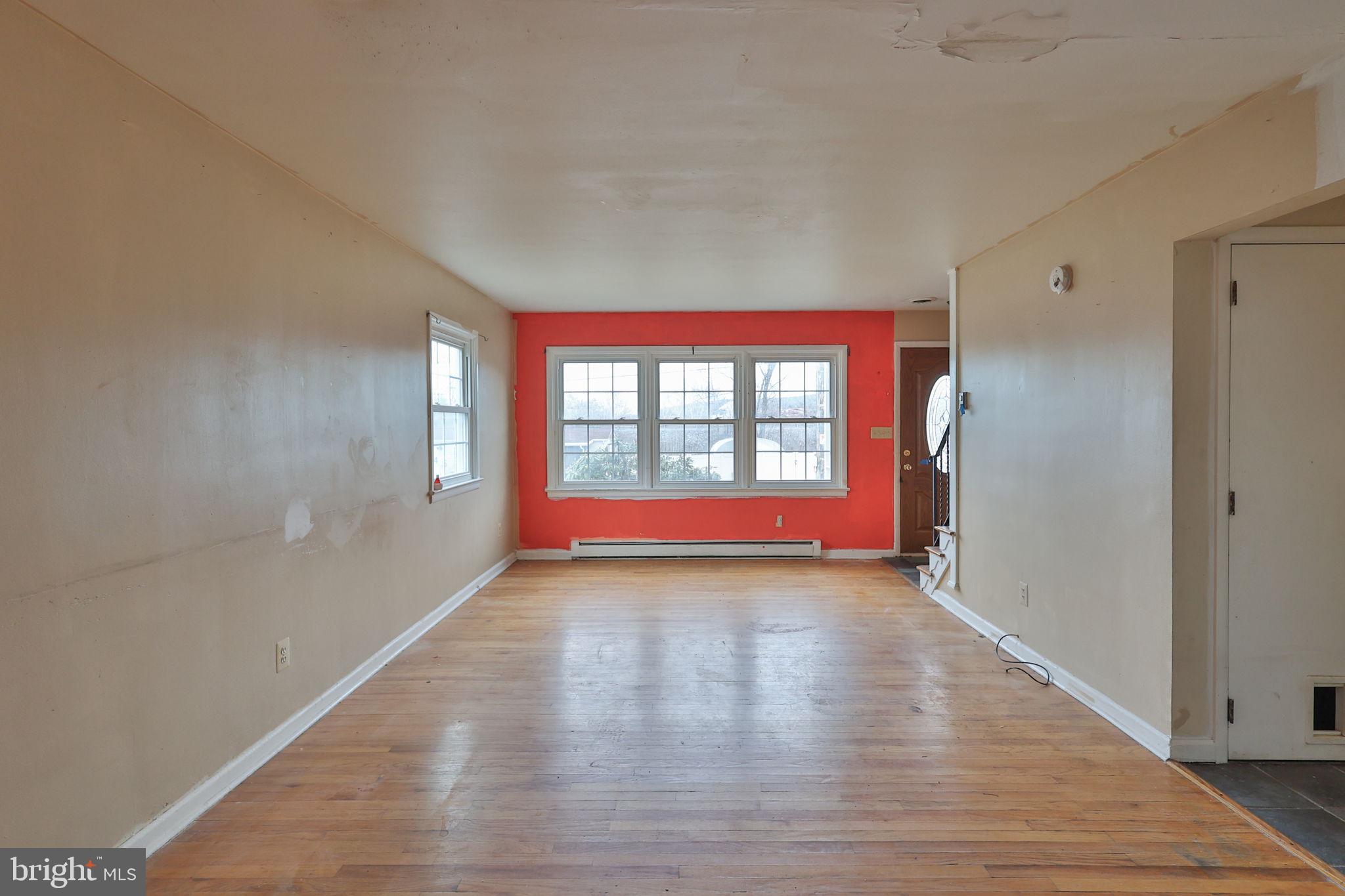 210 South 16th Street Emmaus, PA 18049 - Photo 30 of 92 a view of an empty room with wooden floor and a window