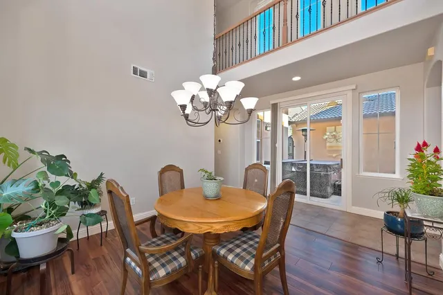 a kitchen with a table chairs refrigerator and cabinets