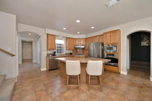 a kitchen with a table chairs and entryway