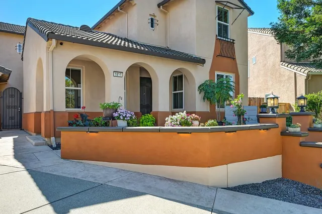 a front view of a house with a garden