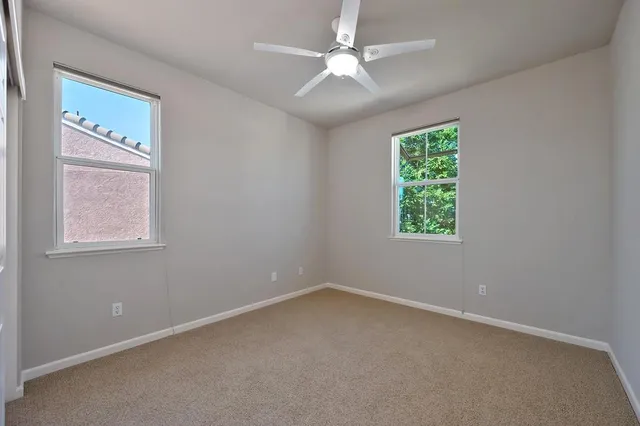 a room with pool table and glass windows
