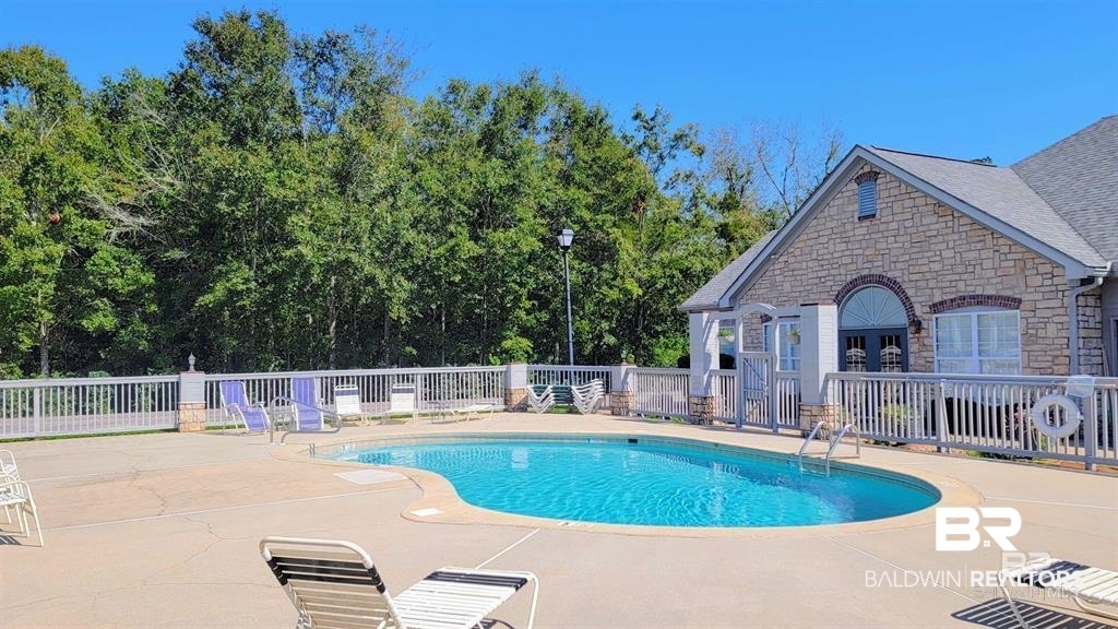 303 Wyld Palms Drive, Unit 303 Foley, AL 36535 - Photo 25 of 36 Community pool featuring a patio