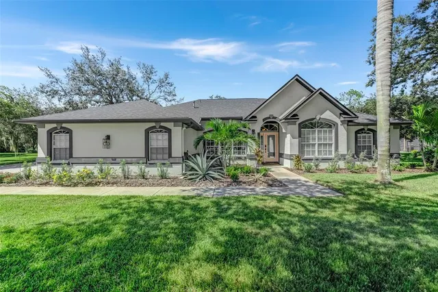 a front view of a house with a garden and yard