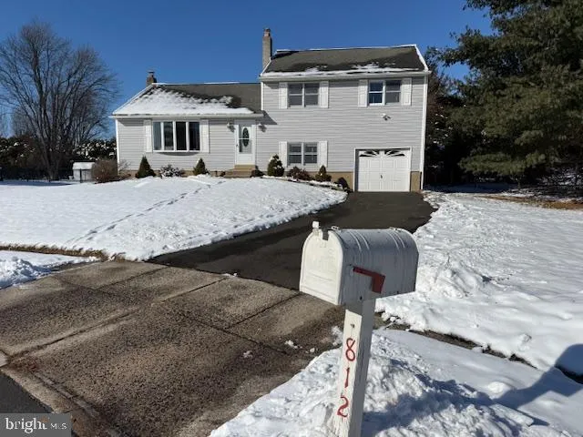 a view of a white house with a yard in front of it