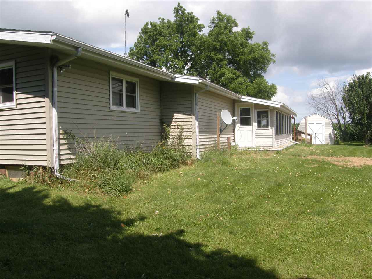 16700 Goodrich Road Durand, IL 61024 - Photo 5 of 18 a backyard of a house with plants and large tree