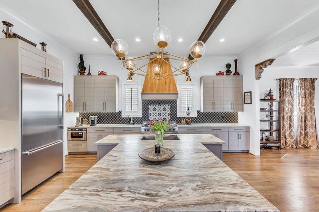 a kitchen with sink refrigerator and microwave