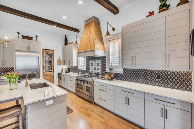 a kitchen with stainless steel appliances granite countertop a stove and a sink