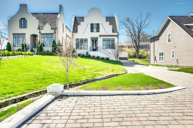 a view of a white house with a swimming pool and a yard
