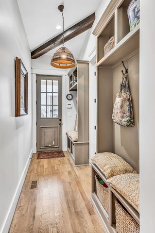 a bathroom with double vanity sinks a vanity a lamp and a mirror