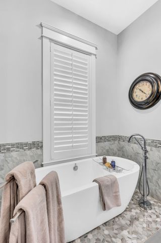 a spacious bedroom with a bed and a table in it