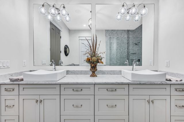a en suite bathroom with a sink a mirror and a shower