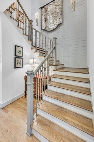 a en suite bathroom with a granite countertop sink a toilet a mirror and vanity