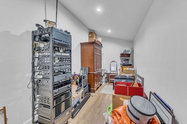 a dining room with furniture large windows and wooden floor