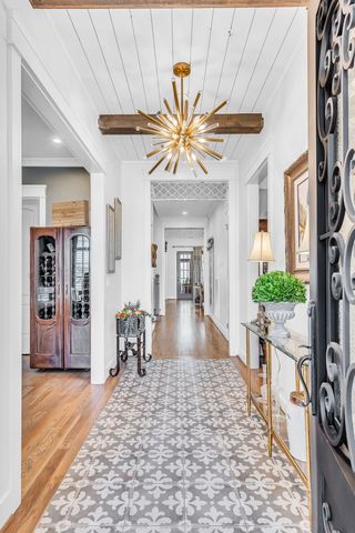 a view of a livingroom with a dinning area hardwood floor a ceiling fan and window