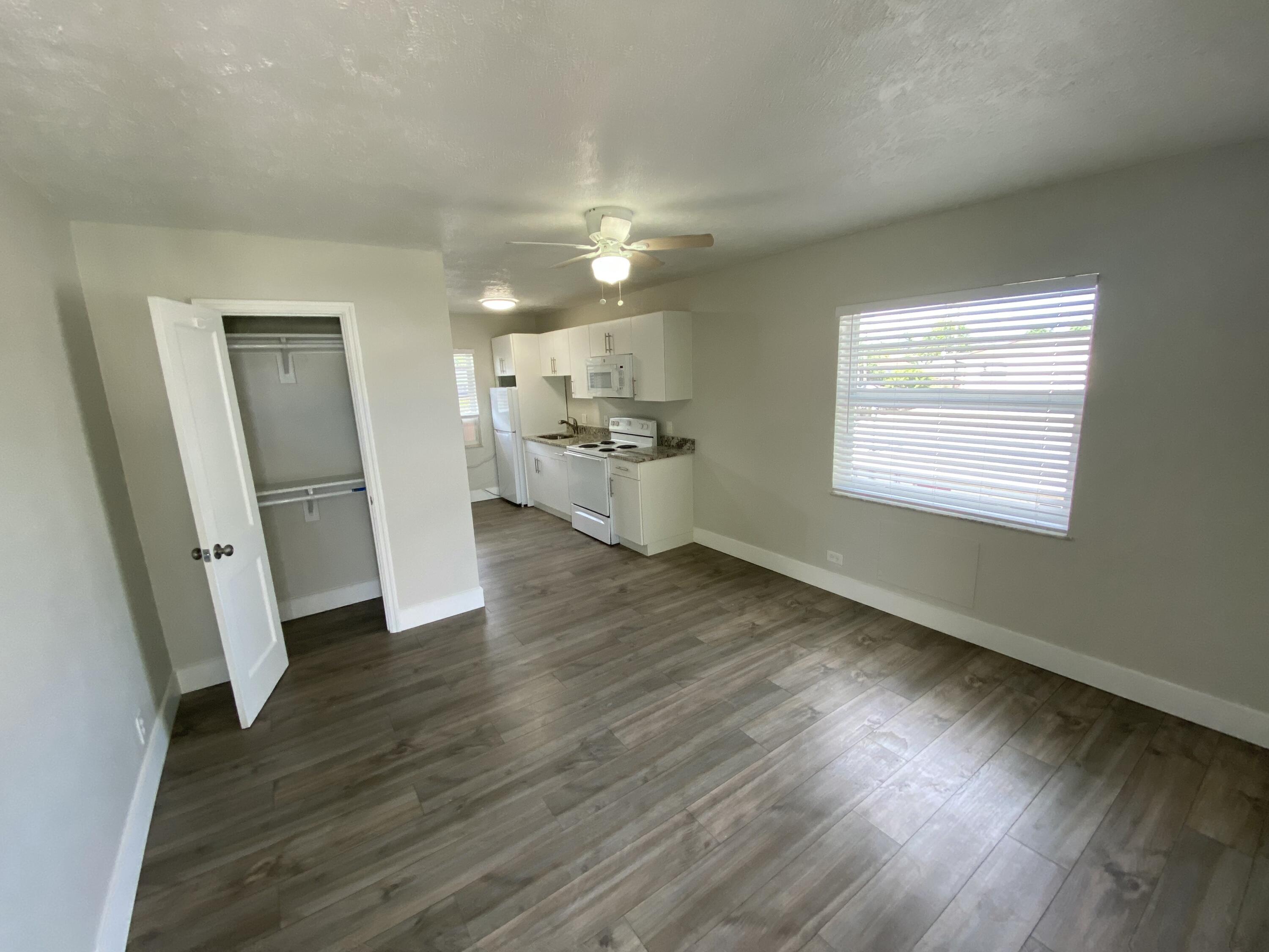 605 North Federal Highway, Unit 12 Lake Worth Beach, FL 33460 - Photo 2 of 9 an empty room with wooden floor and windows