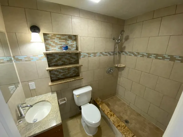 a bathroom with a toilet and a shower