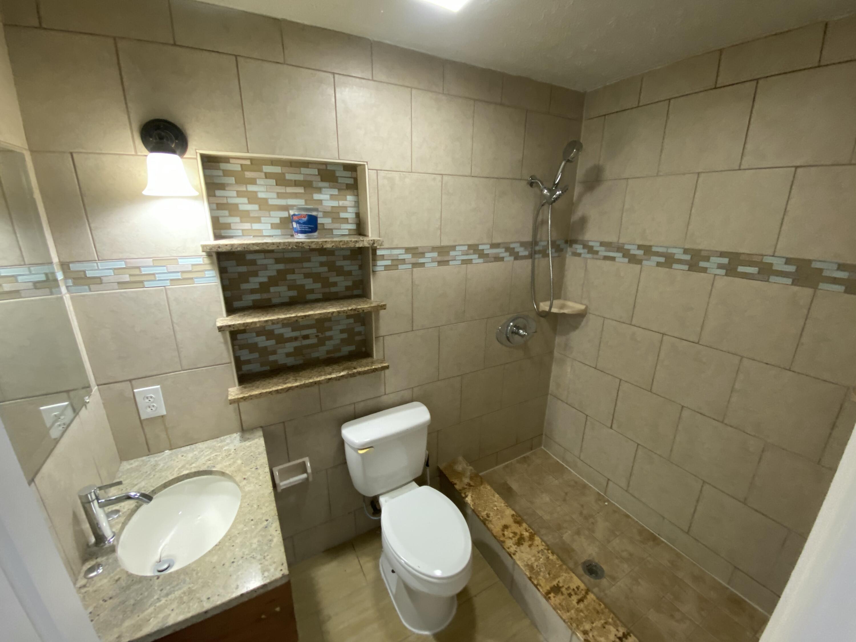 605 North Federal Highway, Unit 12 Lake Worth Beach, FL 33460 - Photo 6 of 9 a bathroom with a toilet and a shower