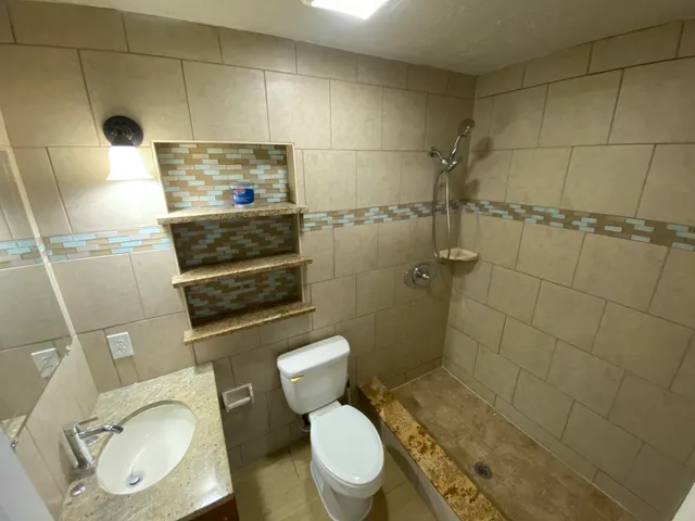 a bathroom with a toilet and a shower