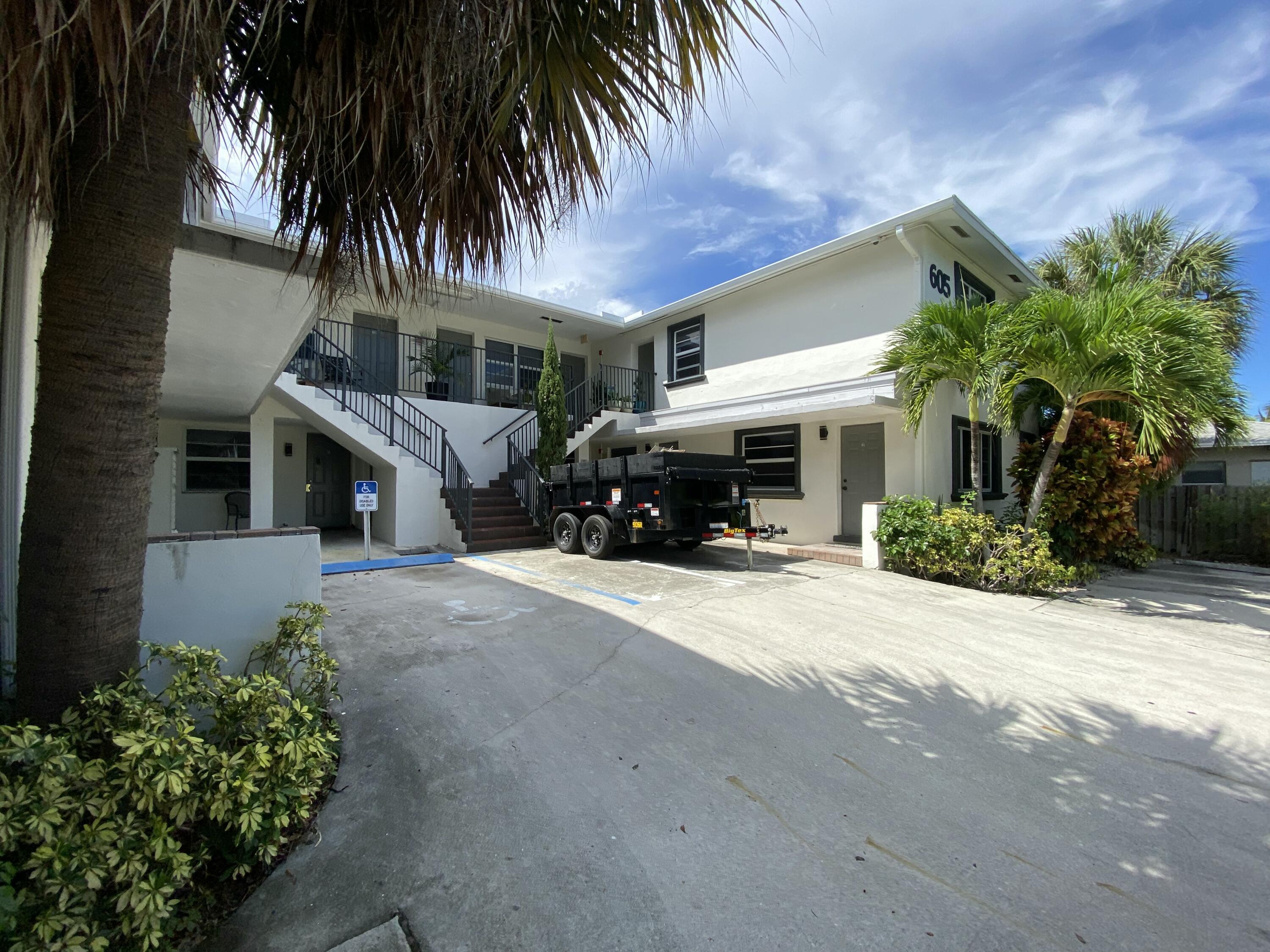 605 North Federal Highway, Unit 12 Lake Worth Beach, FL 33460 - Photo 9 of 9 a front view of a house with a garden and a garage