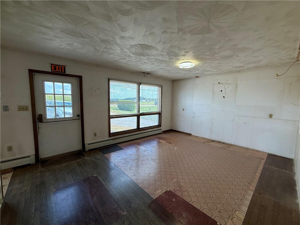 766 North Pike Road Cabot, PA 16023 - Photo 2 of 11 an empty room with wooden floor and windows