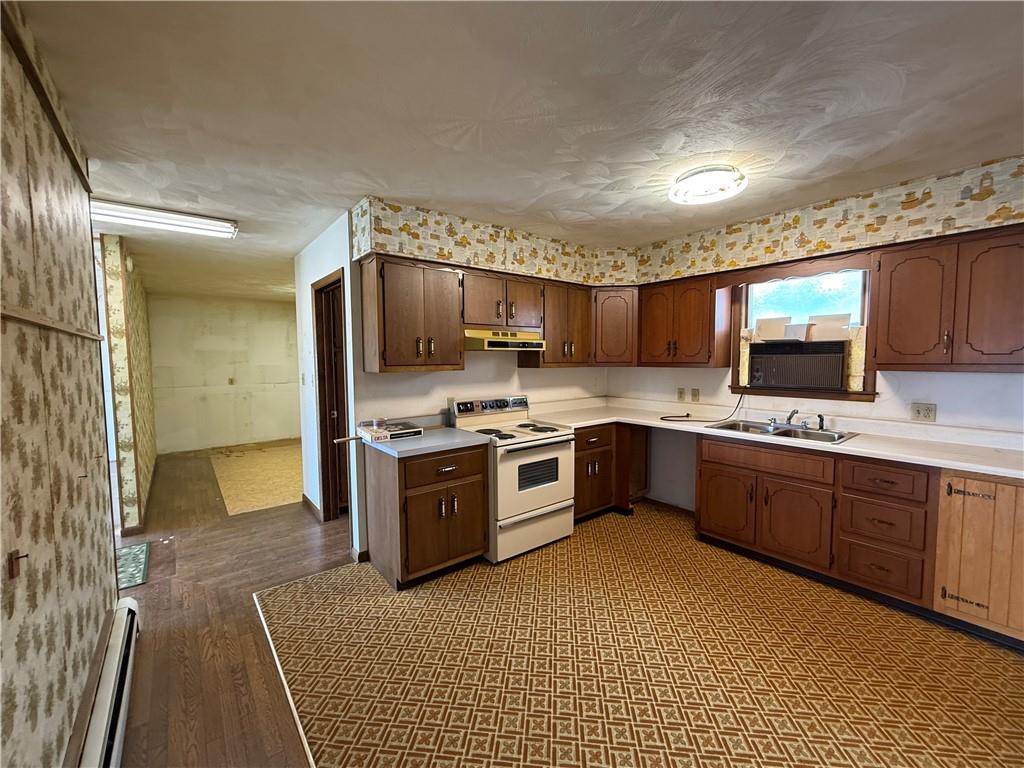 766 North Pike Road Cabot, PA 16023 - Photo 6 of 11 a large kitchen with stainless steel appliances granite countertop a stove granite counter tops and white cabinets