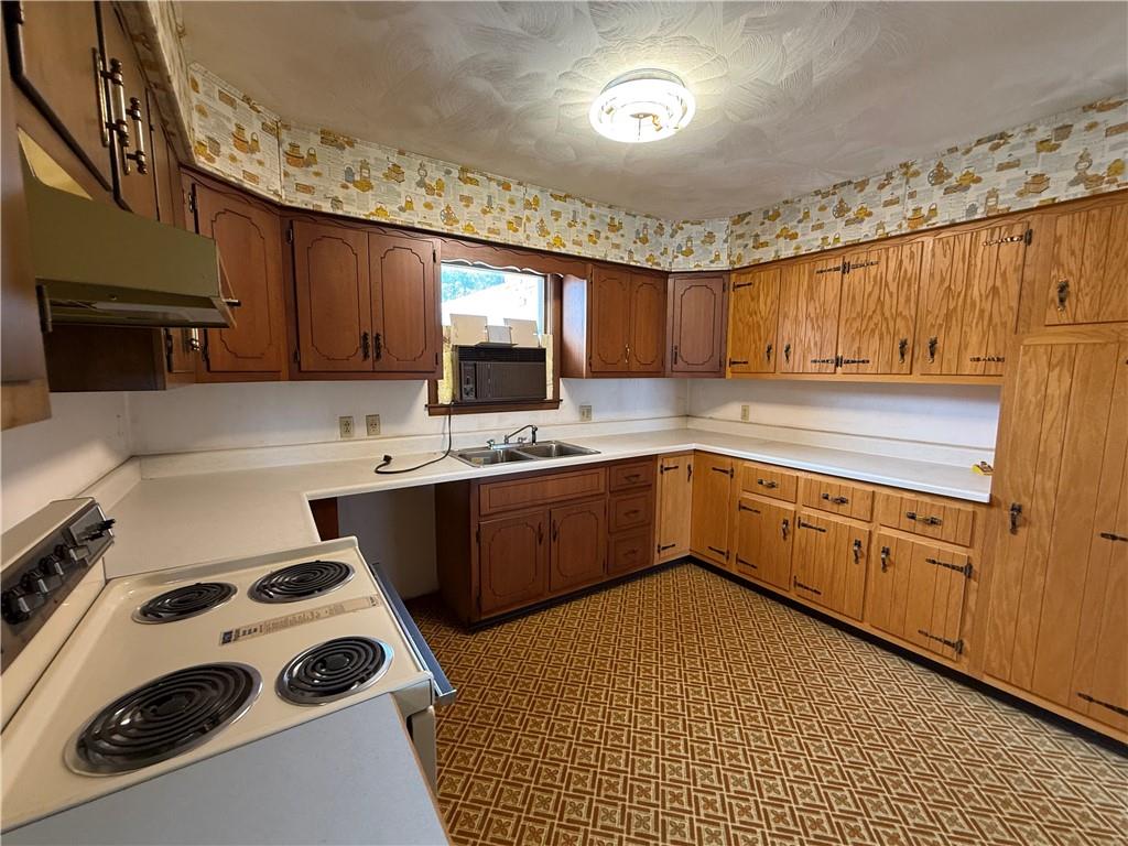 766 North Pike Road Cabot, PA 16023 - Photo 7 of 11 a kitchen with a sink a stove and cabinets