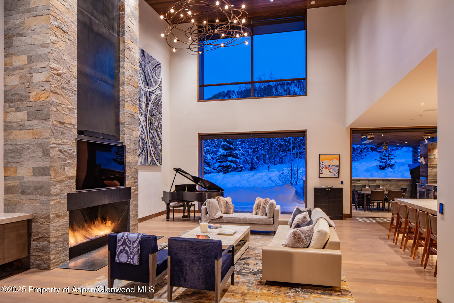 130 Primrose Path Aspen, CO 81611 - Photo 4 of 94 a living room with furniture a fireplace and a kitchen view
