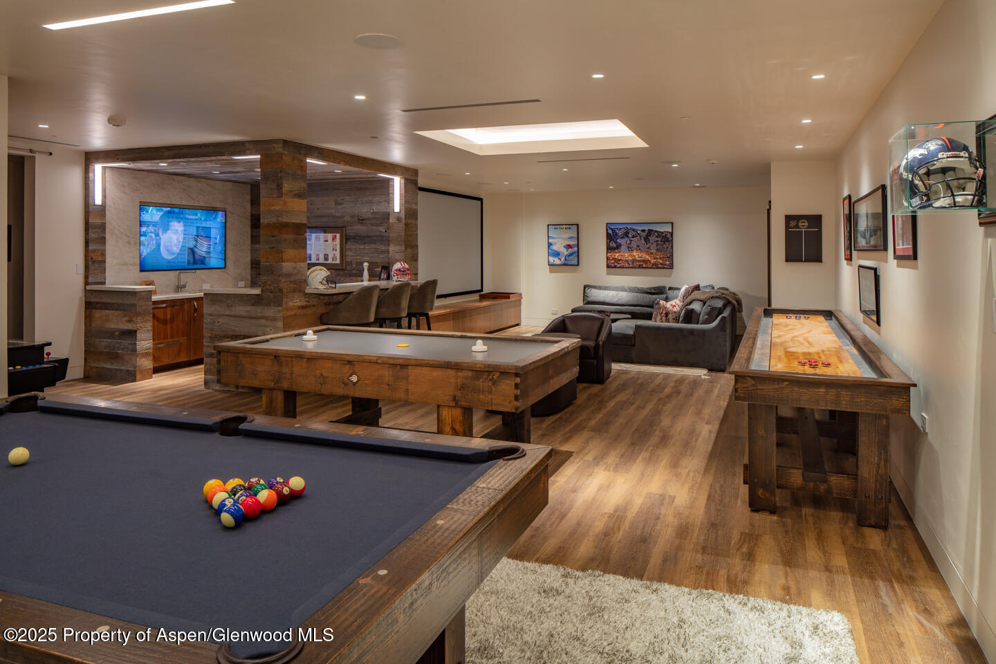 130 Primrose Path Aspen, CO 81611 - Photo 59 of 94 a living room with stainless steel appliances kitchen island furniture and a wooden floor