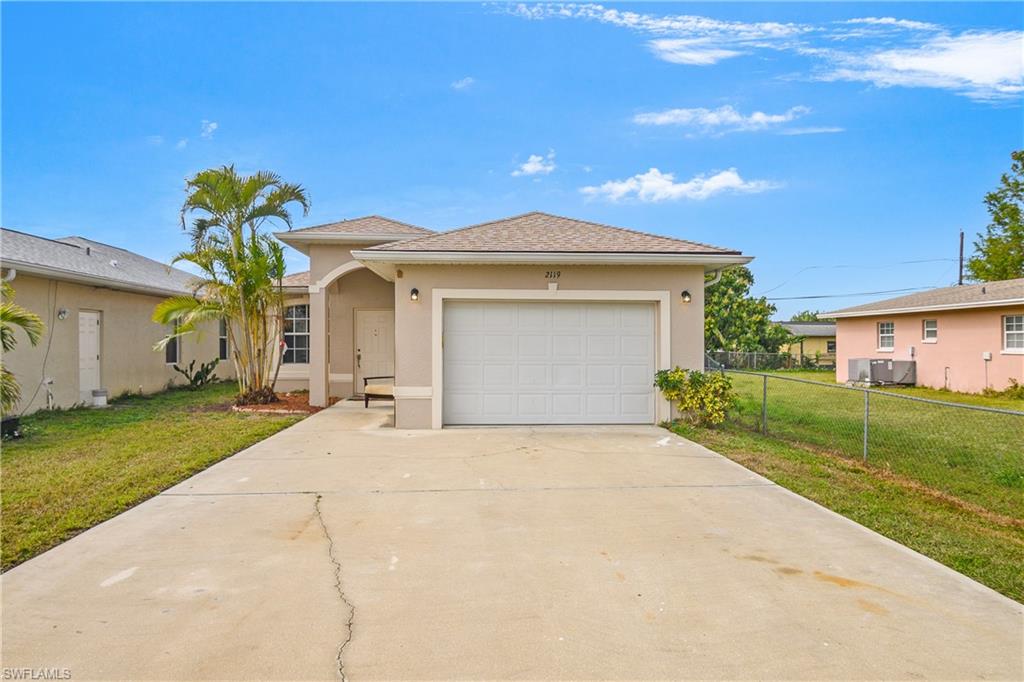 View of front of home with a garage and long driveway for your Boat
