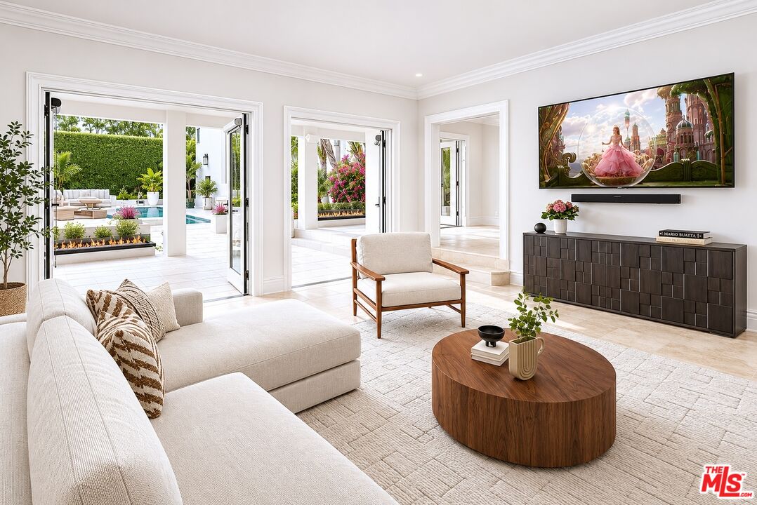 607 North Hillcrest Road Beverly Hills, CA 90210 - Photo 4 of 16 a living room with furniture and a flat screen tv