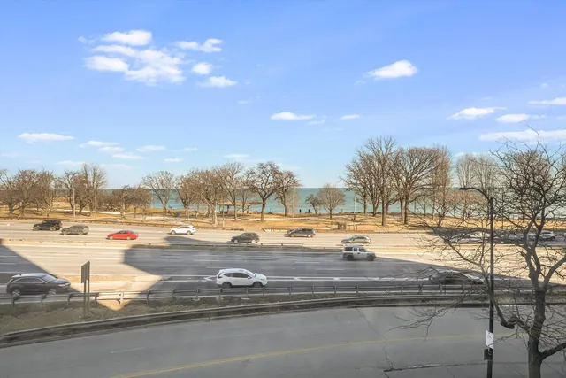 a view of swimming pool with outdoor seating and city view