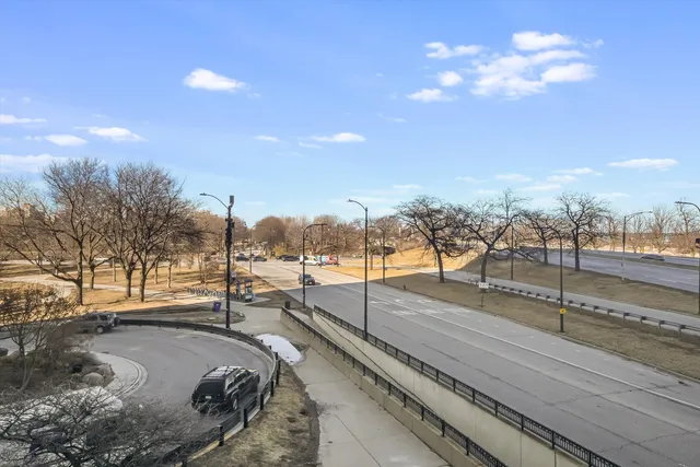 a kitchen with stainless steel appliances granite countertop a refrigerator a stove and a sink with wooden cabinets