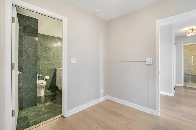 a bathroom with a double vanity sink toilet and mirror