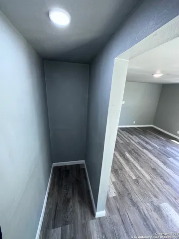 a view of hallway with wooden floor