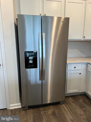 a view of a refrigerator in kitchen and a stove