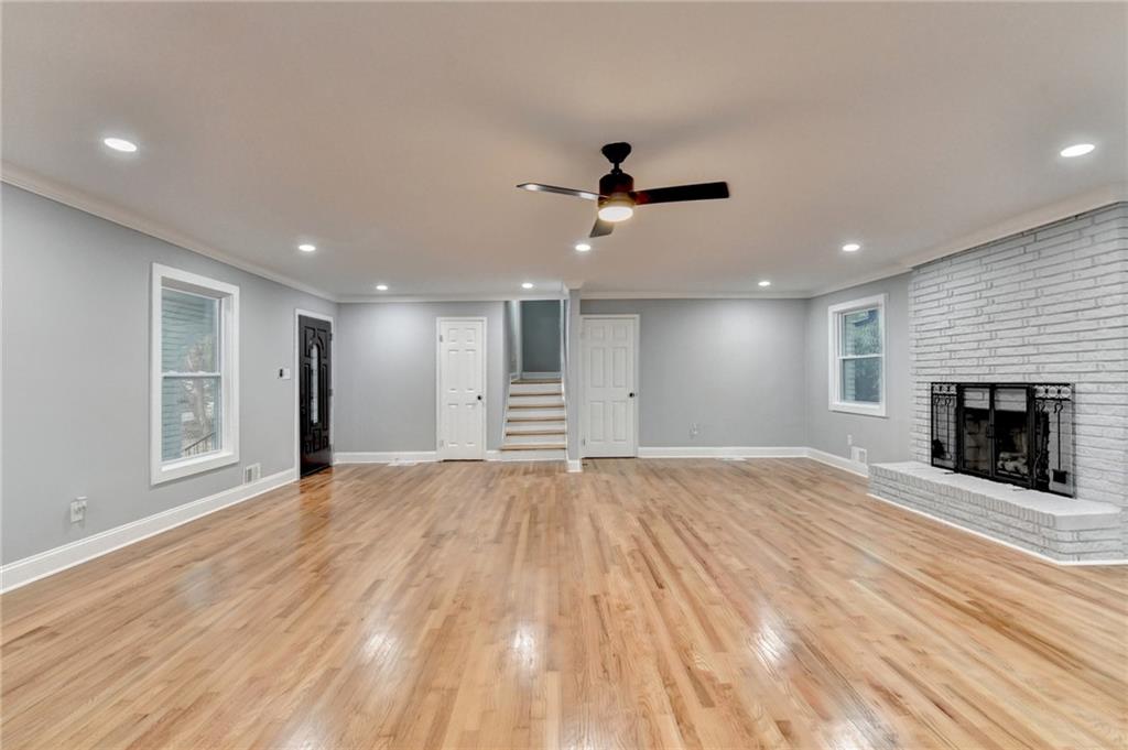 5169 Oxbow Road Stone Mountain, GA 30087 - Photo 12 of 58 a view of empty room with wooden floor and fireplace