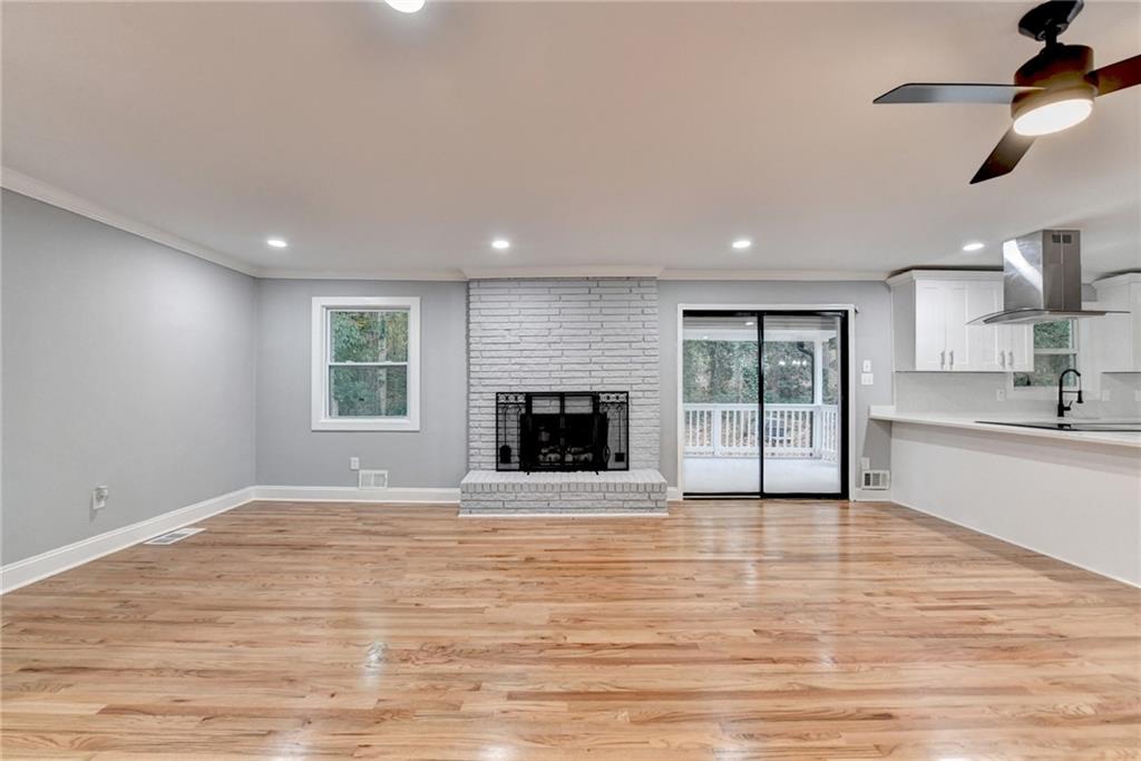 5169 Oxbow Road Stone Mountain, GA 30087 - Photo 13 of 58 a view of an empty room with a kitchen and a window