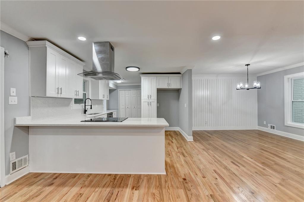 5169 Oxbow Road Stone Mountain, GA 30087 - Photo 14 of 58 a large kitchen with stainless steel appliances a large counter top a sink a refrigerator and a fireplace
