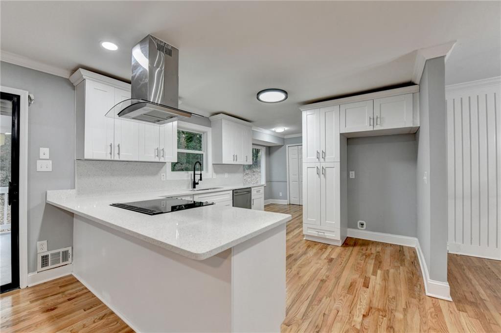 5169 Oxbow Road Stone Mountain, GA 30087 - Photo 16 of 58 a kitchen that has a sink a stove and a wooden floor