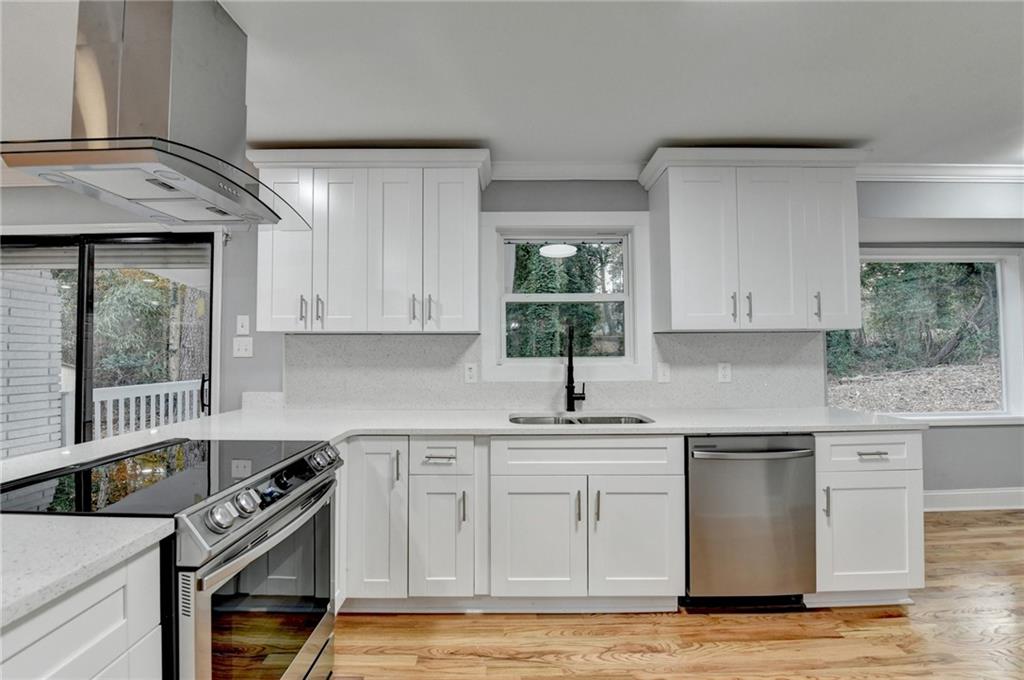 5169 Oxbow Road Stone Mountain, GA 30087 - Photo 17 of 58 a kitchen with stainless steel appliances granite countertop a sink stove and refrigerator